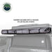 Image of an OVS HD Nomadic 2-person car-side shower and privacy room fully packed on a roof rack and secured with rugged nylon Velcro straps, shown in side view on a white background.