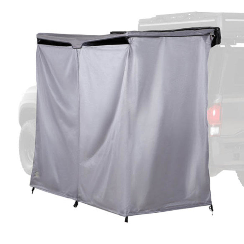 Image of an OVS HD Nomadic 2-person car-side shower and privacy room fully deployed on a vehicle, grey fabric panels forming an enclosed space, shown in angled side view on a white background.