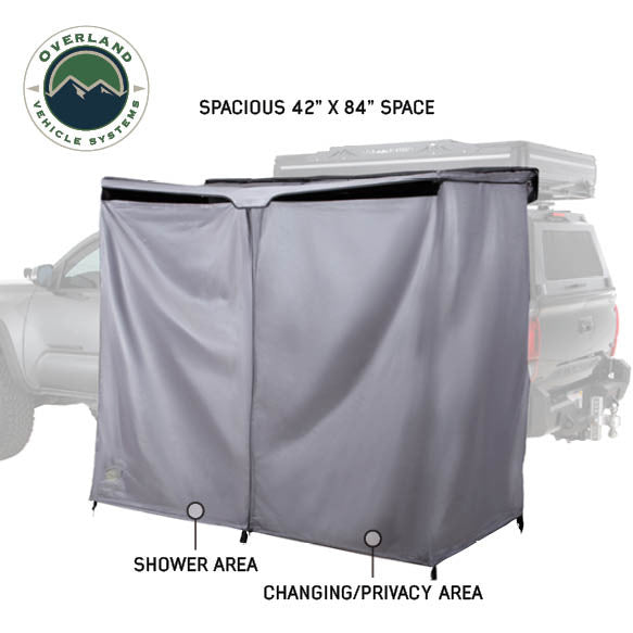 Image of an OVS HD Nomadic 2-person car-side shower and privacy room showing a spacious 42" x 84" interior with separate shower and changing areas, grey fabric enclosure displayed in angled side view on a white background.