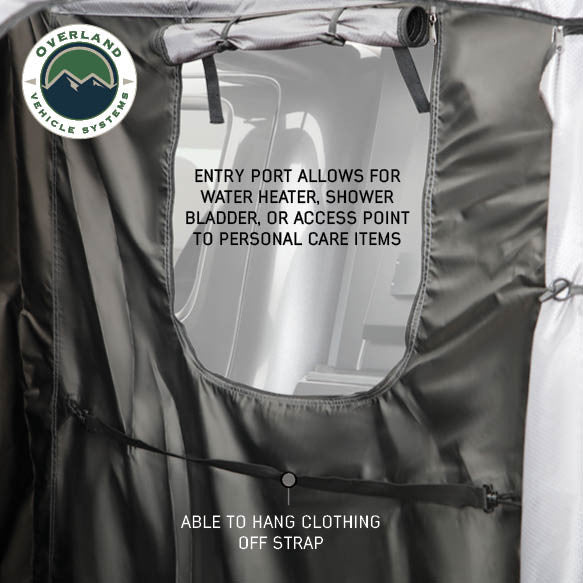 Image of a close-up of an OVS HD Nomadic 2-person car-side shower and privacy room interior showing an entry port for shower accessories and a built-in strap for hanging clothing, displayed on a white background.