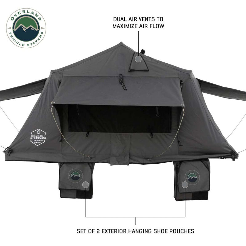 Image of a dark grey Nomadic 3 Extended roof top tent with dual air vents and two exterior hanging shoe pouches. The tent is shown from a head-on, front view on a white background