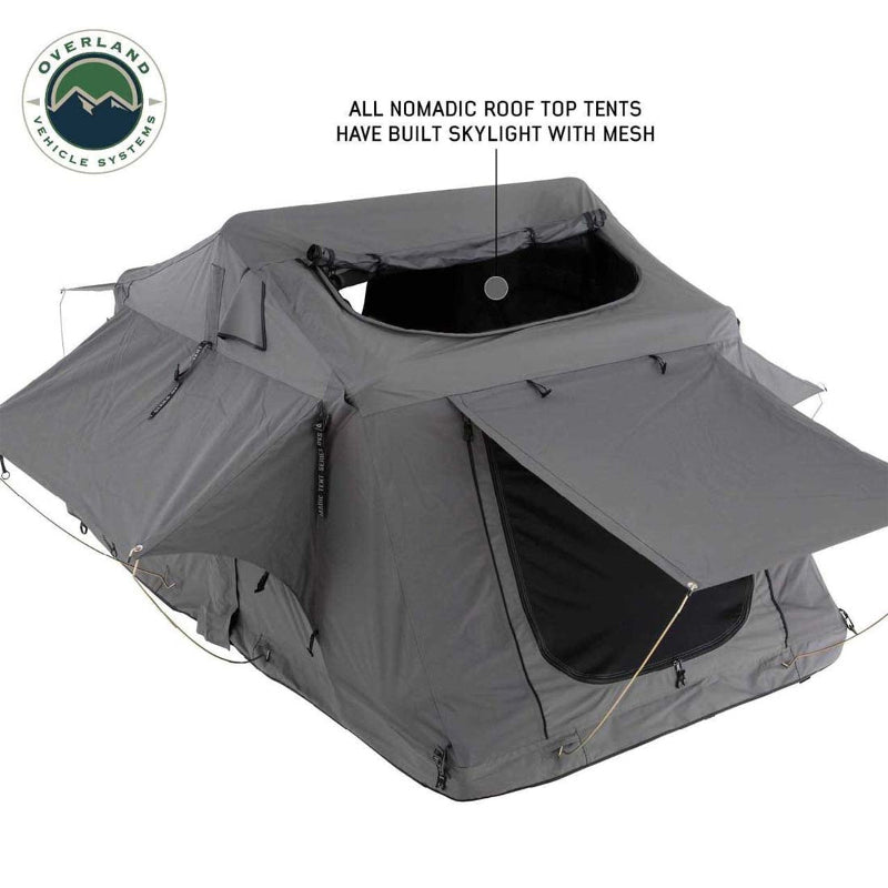 Image of a Nomadic 3 Extended roof top tent shown from a side and top-down angled view, with the built-in skylight with mesh and a side window awning open. The tent is dark grey and displayed on a white background