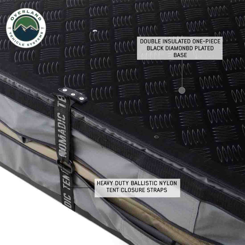 Image showcasing the base and closure mechanism of a rooftop tent, highlighting a double-insulated one-piece black diamond plate base and heavy-duty ballistic nylon tent closure straps. The "Overland Vehicle Systems" logo is in the top left corner