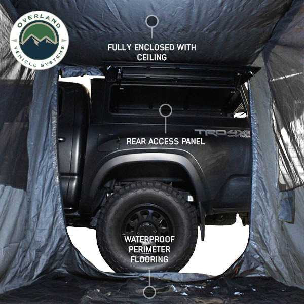 Image of the interior of a vehicle-mounted awning room enclosure showing a fully enclosed ceiling, rear access panel to the truck bed, and waterproof perimeter flooring, viewed from inside on a white background.