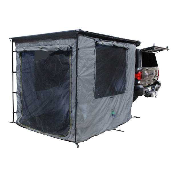 Image of a vehicle-mounted awning room enclosure fully deployed at the rear of a pickup truck, grey fabric with mesh window panels, rectangular tent-style design attached to an open tailgate, shown in angled rear and side view on a white background.