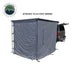 Image of a vehicle-mounted awning room enclosure attached to a 6.5-foot awning at the rear of a pickup truck, solid grey fabric walls fully enclosed, shown in angled rear and side view on a white background.