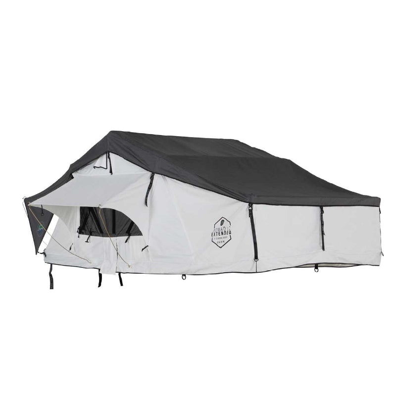 Image of a white Nomadic Extended rooftop tent with a dark grey roof cover, fully set up and extended, viewed from the front and side on a white background