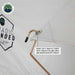 Image of a close-up view of a heavy-duty rain fly rod with a protective end cap and water runoff point, attached to the white fabric of the Nomadic Extended tent, set against a white background