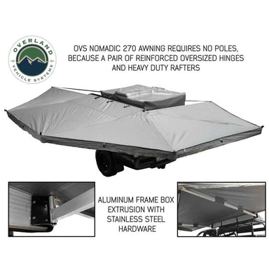 Image of a grey OVS Nomadic 270 Awning partially deployed with no poles, attached to the side of an overland trailer. Two close-up inset images highlight the aluminum frame, oversized hinges, and stainless steel hardware of the awning