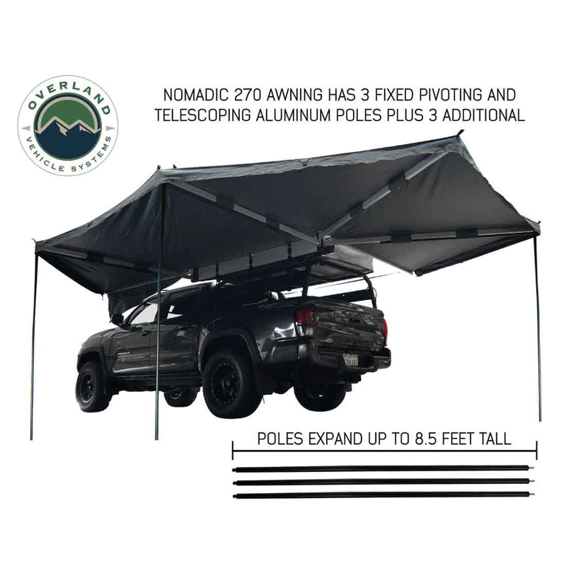 Image of a grey OVS Nomadic 270 Awning fully deployed with three telescoping aluminum poles extending to the ground for support. The awning is attached to the side of a black pickup truck with an overland rack and a rooftop tent. A graphic shows the extendable poles