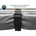 Image of the OVS Nomadic Awning rolled up and secured with a large heavy-duty Velcro strap for storage. The awning fabric is a dark grey color