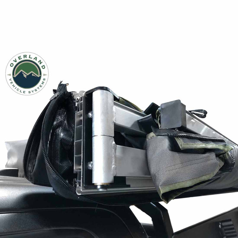 Image of the OVS Nomadic Awning showing a close-up of the reinforced oversized hinges and heavy-duty rafters. The awning is partially unzipped from its travel cover, revealing its internal structure