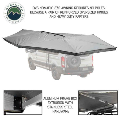 Image of the OVS Nomadic 270 Awning fully deployed on the rear and side of a vehicle, highlighting its poleless design. The awning is grey on top with a black underside