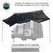 Image of the OVS Nomadic 270 Awning fully deployed on the side and rear of a vehicle, supported by three fixed pivoting and telescoping aluminum poles. The awning is black on both sides