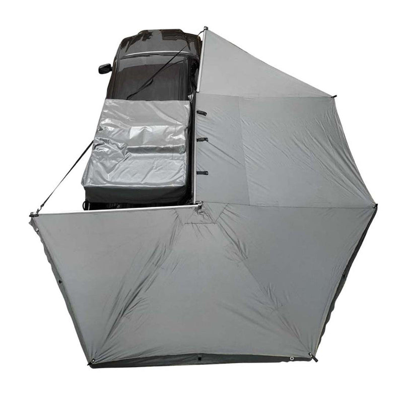 Image of the OVS Nomadic 270 Awning fully deployed from a vehicle, seen from a high angle to show the full 270-degree coverage of the light grey poly cotton ripstop canvas material
