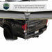 Image of the OVS Nomadic Awning showing an additional tie-down point for water runoff, attached to the back of a pickup truck to prevent puddling during storms