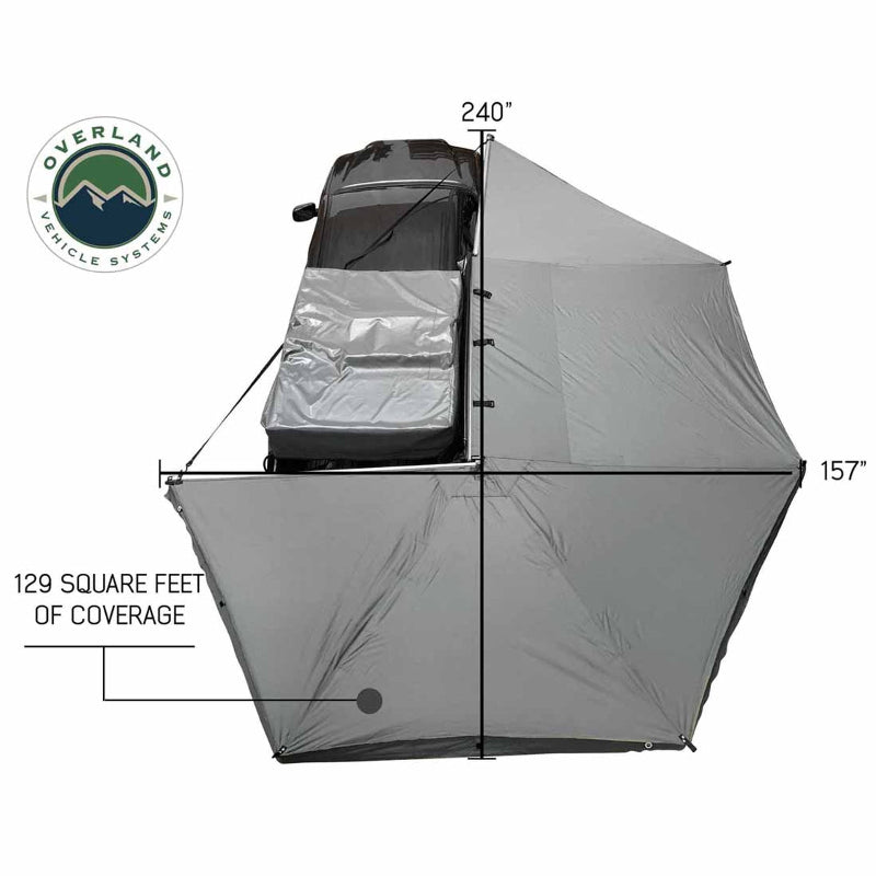 Image of the OVS Nomadic 270 Awning fully deployed from a vehicle, seen from a high angle to show the full 270-degree coverage of the light grey poly cotton ripstop canvas material with dimensions of 240 inches by 157 inches and 129 square feet of coverage