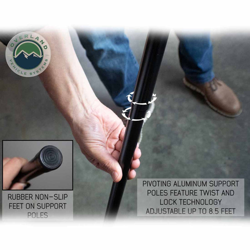 Image of a hand twisting the pivoting aluminum support pole for the OVS Nomadic Awning, demonstrating the twist and lock technology. An inset image shows the rubber non-slip foot at the end of the support pole.