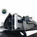 Image of the Overland Vehicle Systems Nomadic 180 Awning partially folded and stowed, showcasing the durable black travel cover and the robust aluminum frame. The awning is mounted on a vehicle roof rack, seen from an angled side view