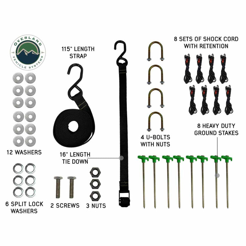 This image displays the full hardware kit for the Nomadic 270 Awning, including: 12 washers, 6 split lock washers, 2 screws, 3 nuts, a 115" length strap, a 16" length tie-down, 4 U-bolts with nuts, 8 sets of shock cord with retention, and 8 heavy-duty ground stakes. The items are neatly arranged and labeled on a white background, showcasing all components necessary for secure installation