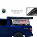 A Nomadic Awning is shown on the top of a blue pickup truck in a black, sealed PVC travel bag. The image also highlights the heavy-duty zippers of the travel bag with a close-up inset and notes the travel cover dimensions: 83" x 7" x 5"