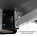Image of the mounting point for the Overland Vehicle Systems Nomadic 180 Awning, highlighting the aluminum frame box extrusion with steel hardware. The underside of the awning fabric and the sturdy bracket are shown up close