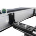 Image of the OVS Nomadic 180° Awning mounting brackets, including a black L-shaped bracket and a slotted flat bracket, shown in a close-up shot on a white background