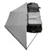 Image of the OVS Nomadic 180° Awning with the optional zip-in wall deployed, showing a top-down view of the gray fabric and the additional wall for a fully enclosed shelter