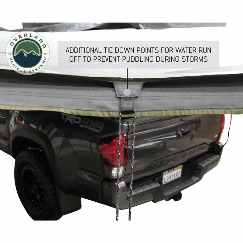 Image of the OVS Nomadic 180° Awning showing a close-up of an additional tie-down point with a rope attached, designed for water run-off to prevent puddling during storms