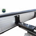Image of a black mounting bracket securing a rooftop tent or awning to a roof rack. The bracket is attached with two bolts, shown against a white background with the Overland Vehicle Systems logo in the top left corner
