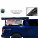 Image of a blue pickup truck with a black rooftop awning in its travel cover, mounted on a rack over the truck bed. An inset image shows a close-up of the heavy-duty zipper on the travel bag, with text noting "BUILT IN 1000G PVC TRAVEL BAG WITH HEAVY DUTY LARGE ZIPPERS" and "TRAVEL COVER DIMENSIONS 83" X 7" X 5""
