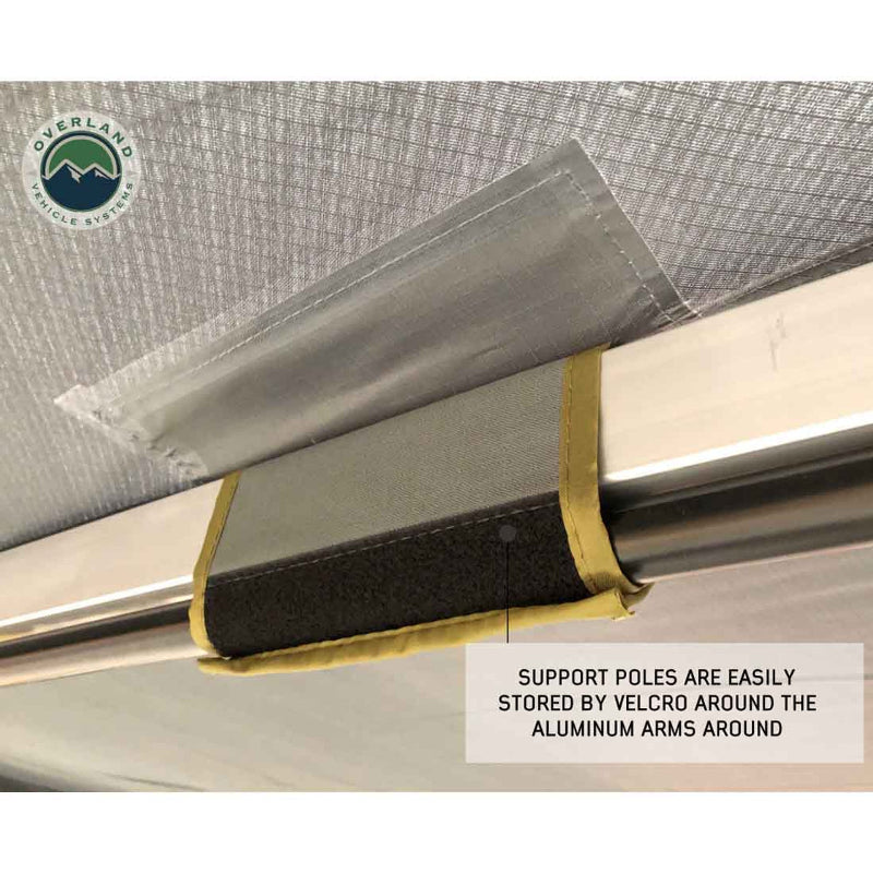 Image of a support pole attached to the aluminum frame of an awning with a black velcro strap. Text notes that "SUPPORT POLES ARE EASILY STORED BY VELCRO AROUND THE ALUMINUM ARMS."