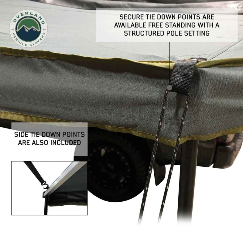 Image of a gray awning with a tie-down strap and cord, demonstrating the "free standing with a structured pole setting" feature. An inset photo shows a close-up of the "side tie-down points"