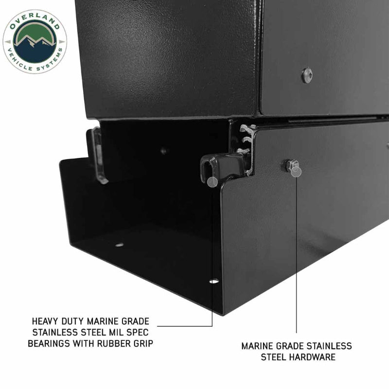 Image of Overland Vehicle Systems slide-out camping storage system corner detail showing marine-grade stainless steel hardware and heavy-duty slide bearings, black powder-coated finish, close-up angled view on a white background.