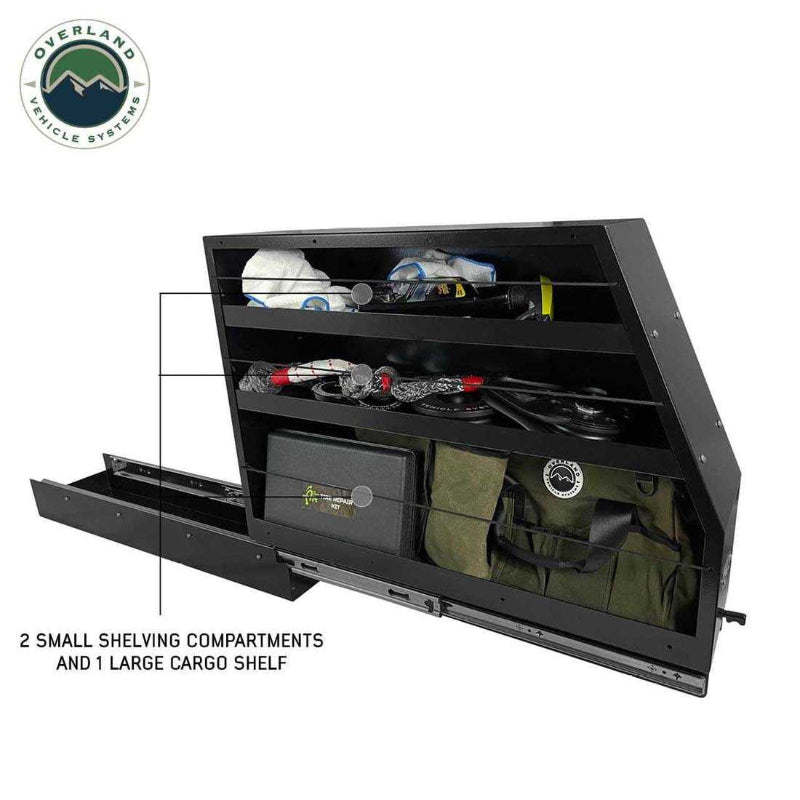 Image of Overland Vehicle Systems slide-out camping storage system partially extended with organized recovery gear in two small upper shelves and one large lower cargo shelf, black powder-coated steel, angled side view on a white background.