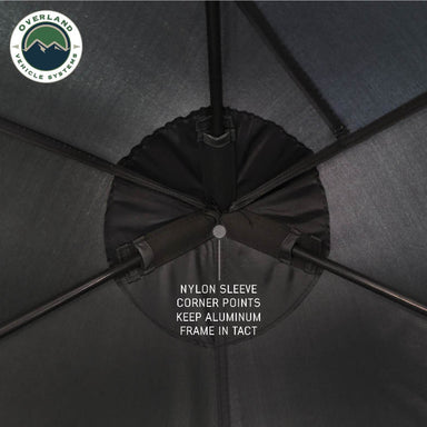 Image of OVS hub-style camping tent interior frame detail showing nylon sleeve corner points securing the aluminum frame, close-up overhead view on a neutral background.