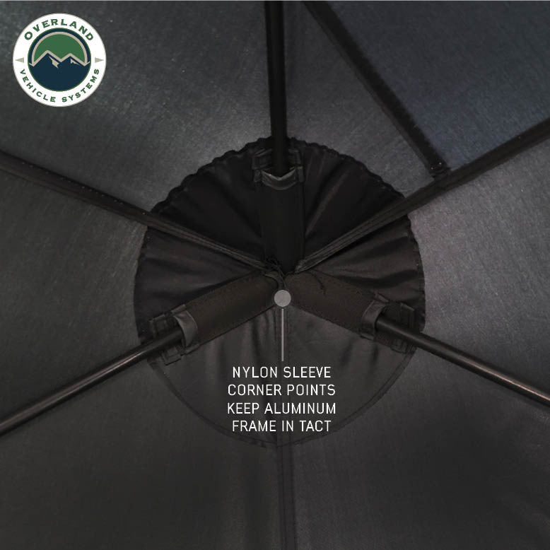 Image of OVS hub-style camping tent interior frame detail showing nylon sleeve corner points securing the aluminum frame, close-up overhead view on a neutral background.