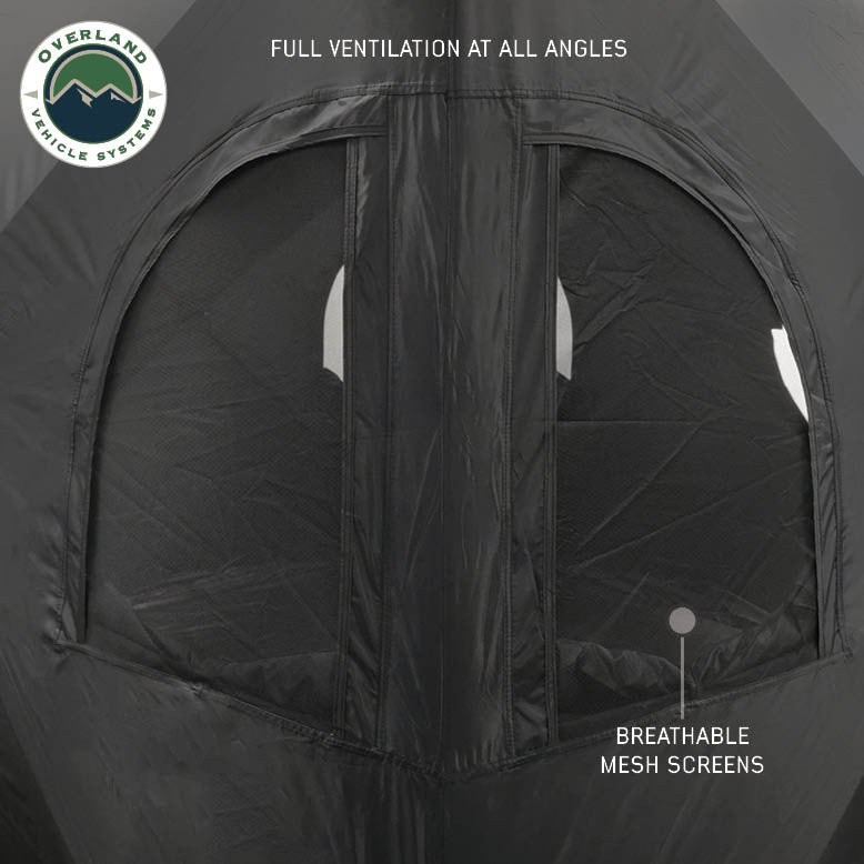 Image of OVS hub-style camping tent window detail showing full ventilation with breathable mesh screens, black fabric construction, close-up exterior view on a neutral background.