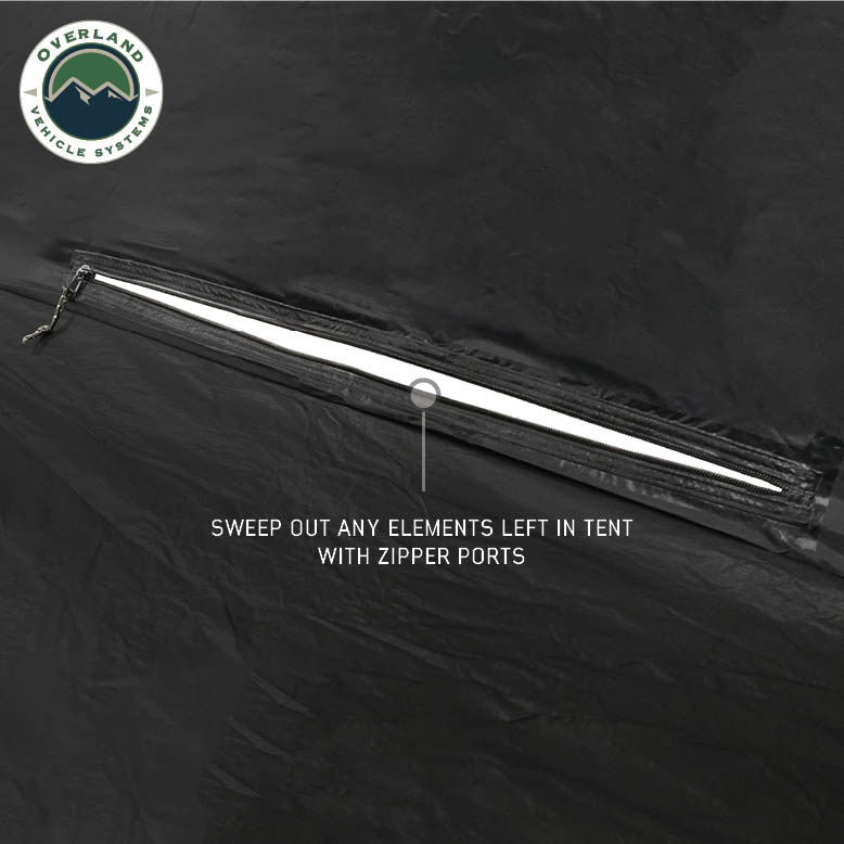 Image of OVS hub-style camping tent floor detail showing zipper port for sweeping out debris, black waterproof fabric construction, close-up angled view on a neutral background.
