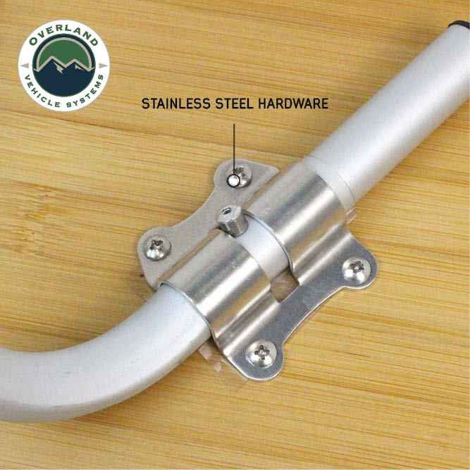 Image of OVS Kick It bi-fold camp table hardware detail showing stainless steel hinge and fasteners mounted to bamboo tabletop, close-up view on a white background.