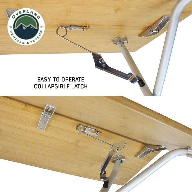 Image of OVS Kick It bi-fold camp table underside showing easy-to-operate collapsible latch and folding leg mechanism attached to bamboo tabletop, close-up angled view on a white background.