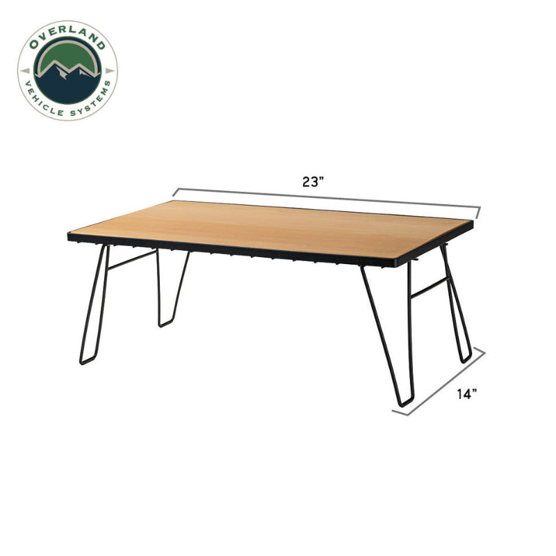 Image of single folding camp table with light wood tabletop and black metal legs showing size dimensions, angled front and side view on white background.