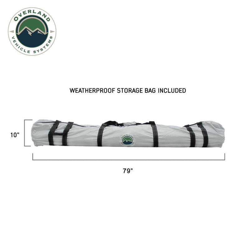 A close-up of the OVS ground tent shows it tightly packed in its included weatherproof storage bag. The bag is light gray with black straps, with dimensions of 79" in length and 10" in diameter