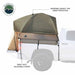 Image of a pickup truck bed tent installed on a white truck, olive green and tan fabric with removable rainfly and adjustable straps, side view showing rear overhang on white background.