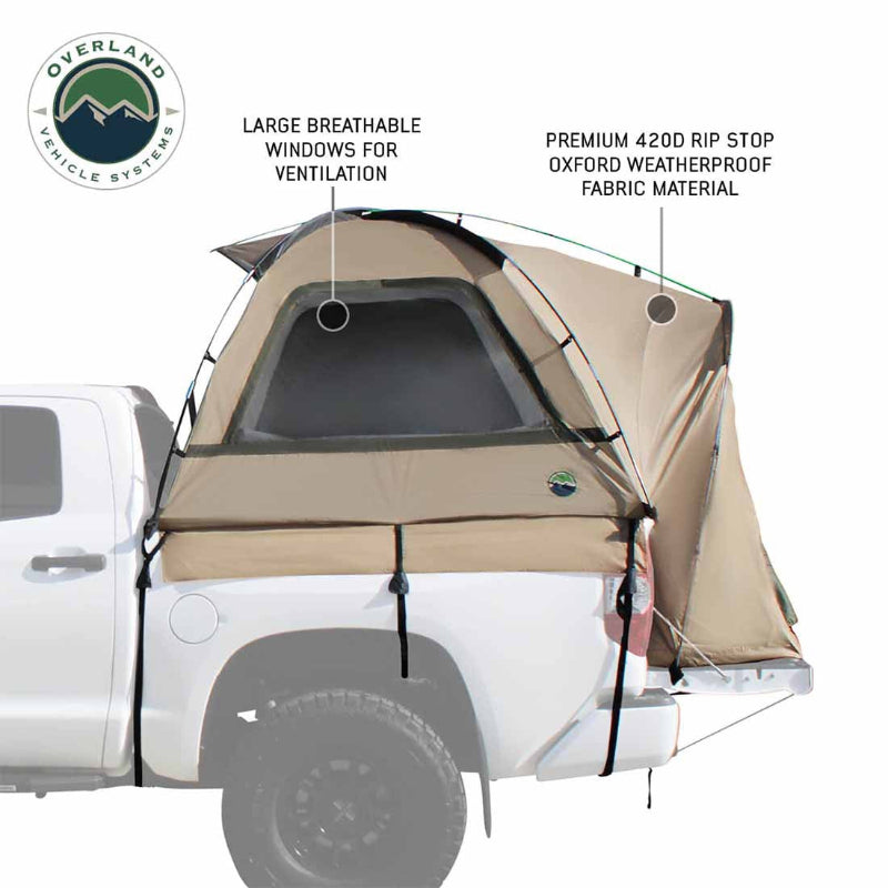 Image of a pickup truck bed tent installed on a white truck, tan and olive green fabric with large breathable mesh window and weatherproof panels, angled side view on white background.