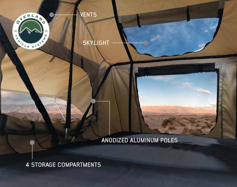 Image showing the interior of a tent, highlighting features such as vents, a skylight, anodized aluminum poles, and four storage compartments, with a desert landscape visible through the windows.