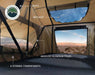 Image showing the interior of a tent, highlighting features such as vents, a skylight, anodized aluminum poles, and four storage compartments, with a desert landscape visible through the windows.