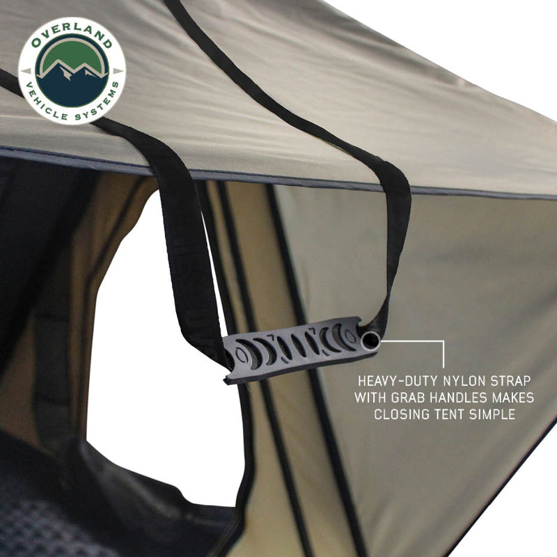 Image displaying an Overland Vehicle Systems XD Series Sherpa Roof Top Tent, fully deployed with a black fabric and light blue interior, shown against a white background. The image highlights key features like heavy-duty SBS zippers, a 5000PU waterproof coat rating, hook and loop to roll up window flaps, and two side support struts