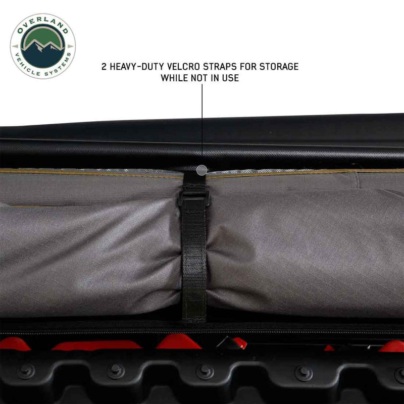 Image of an awning rolled up and secured with a heavy-duty velcro strap for storage, with the text "2 HEAVY-DUTY VELCRO STRAPS FOR STORAGE WHILE NOT IN USE" displayed.