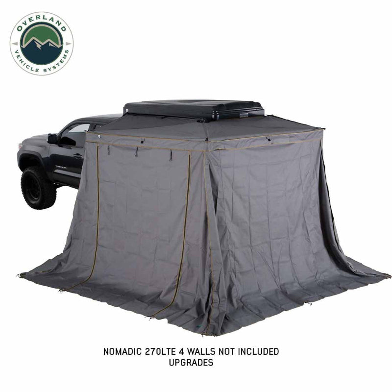 Image of a gray pickup truck with a gray Nomadic 270LTE Awning with 4 walls fully deployed, creating an enclosed shelter, on a white background.